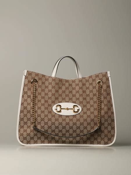 white gucci shopping bag.